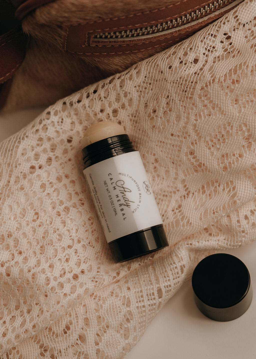 Deodorant stick with a white label on a lace fabric background