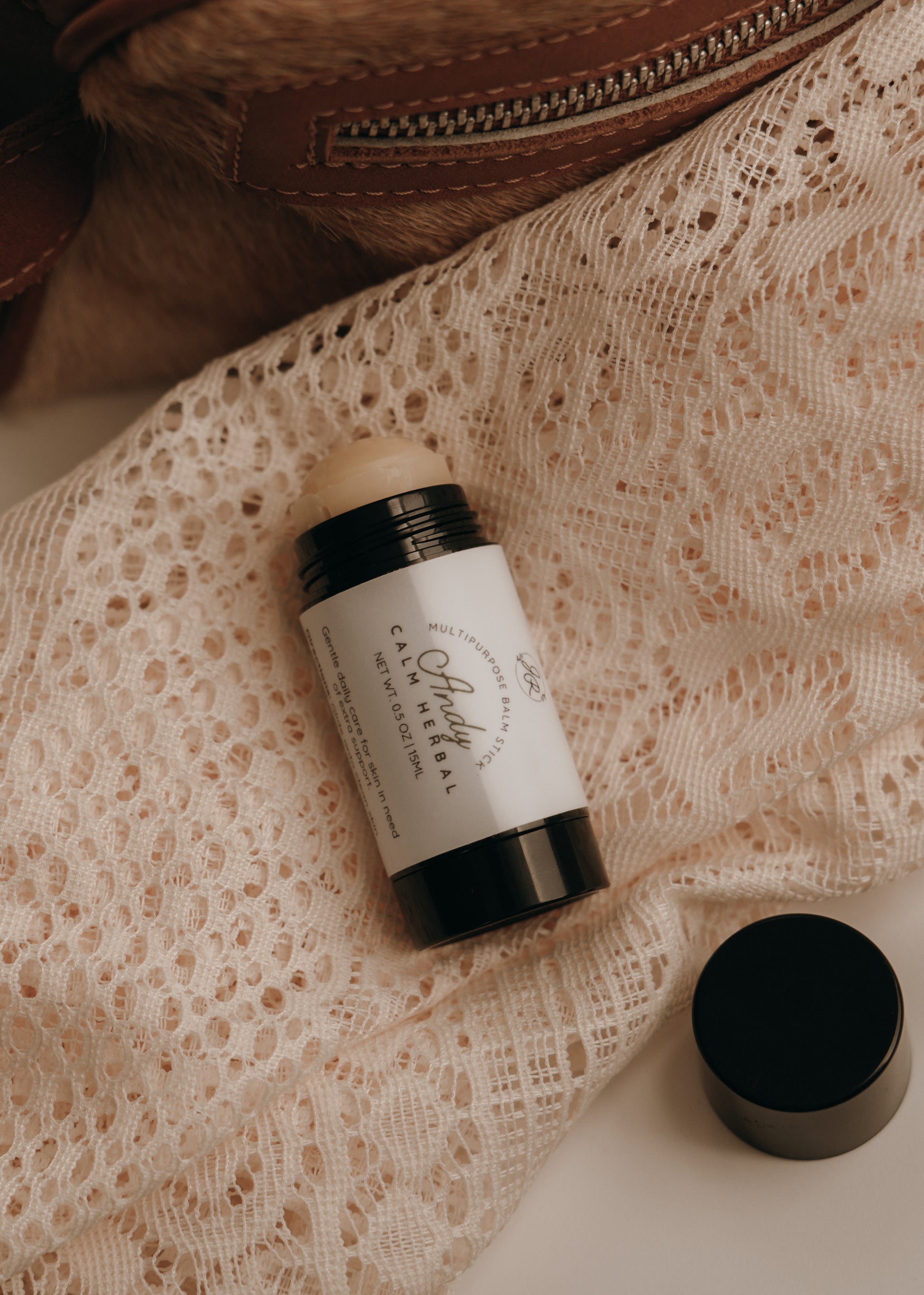 Deodorant stick with a white label on a lace fabric background