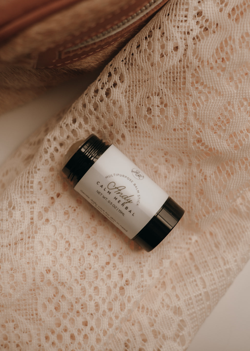 Skincare product on a textured beige surface