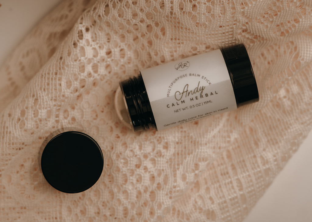 Jar of 'Andy Calm Herbal' balm on a textured beige surface