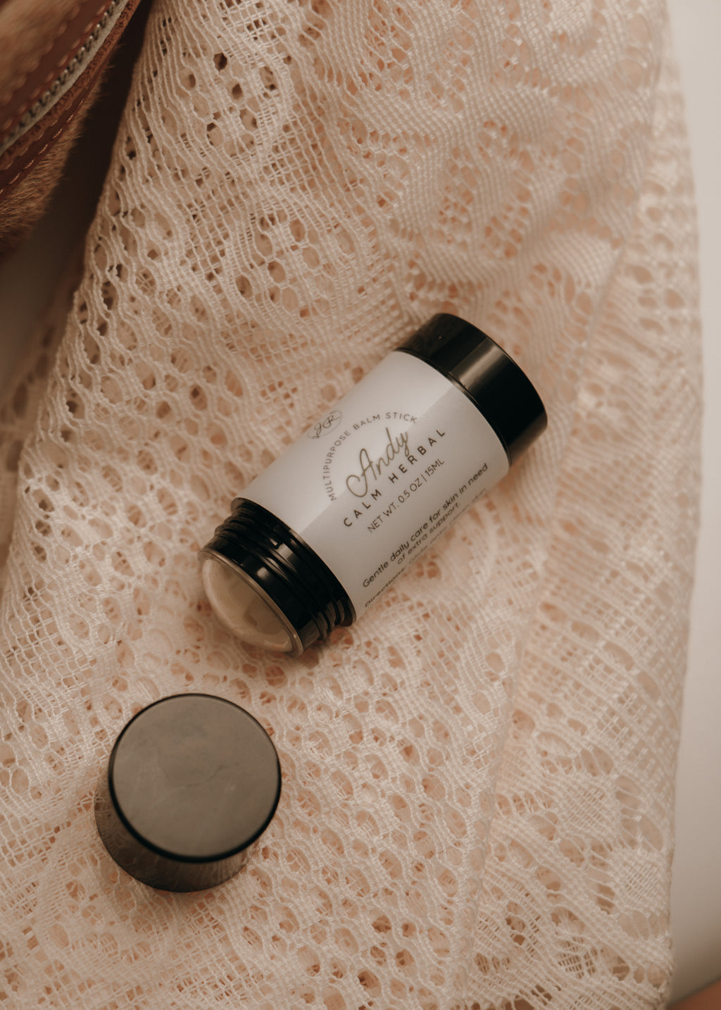 Cosmetic jar with a white label on a textured beige fabric background