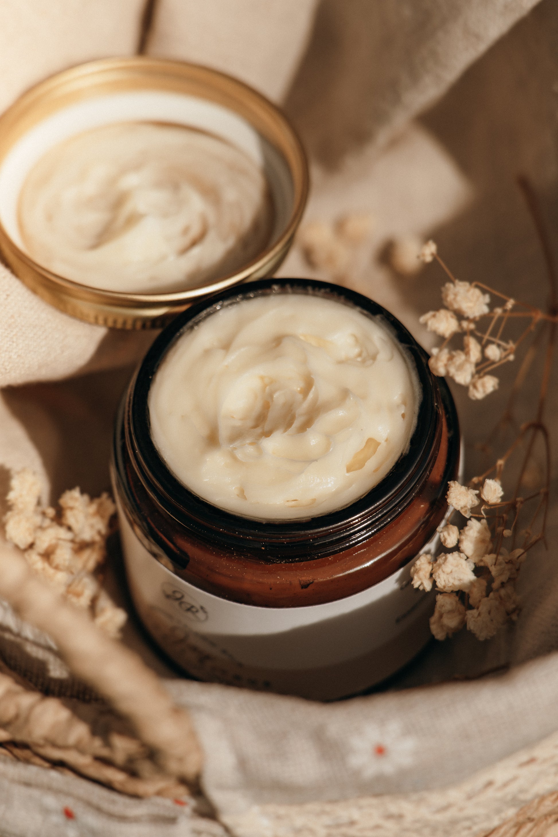 Jar of cream with a lid on a textured surface